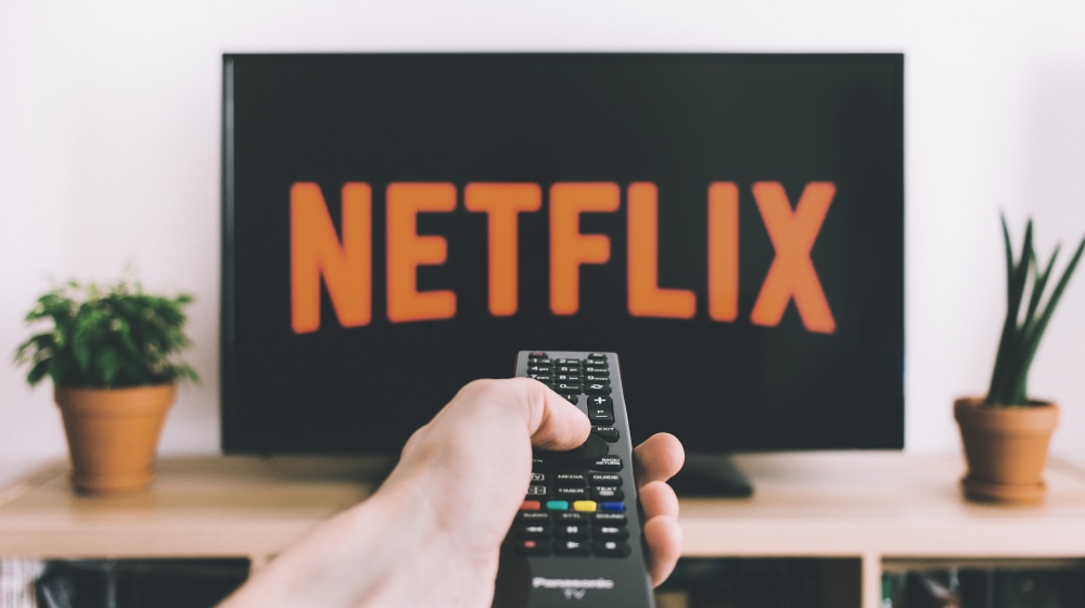 Watching netflix on a flat screen TV | What Netfllix’s GOOP LAB Can Teach Us About Longevity | Featured